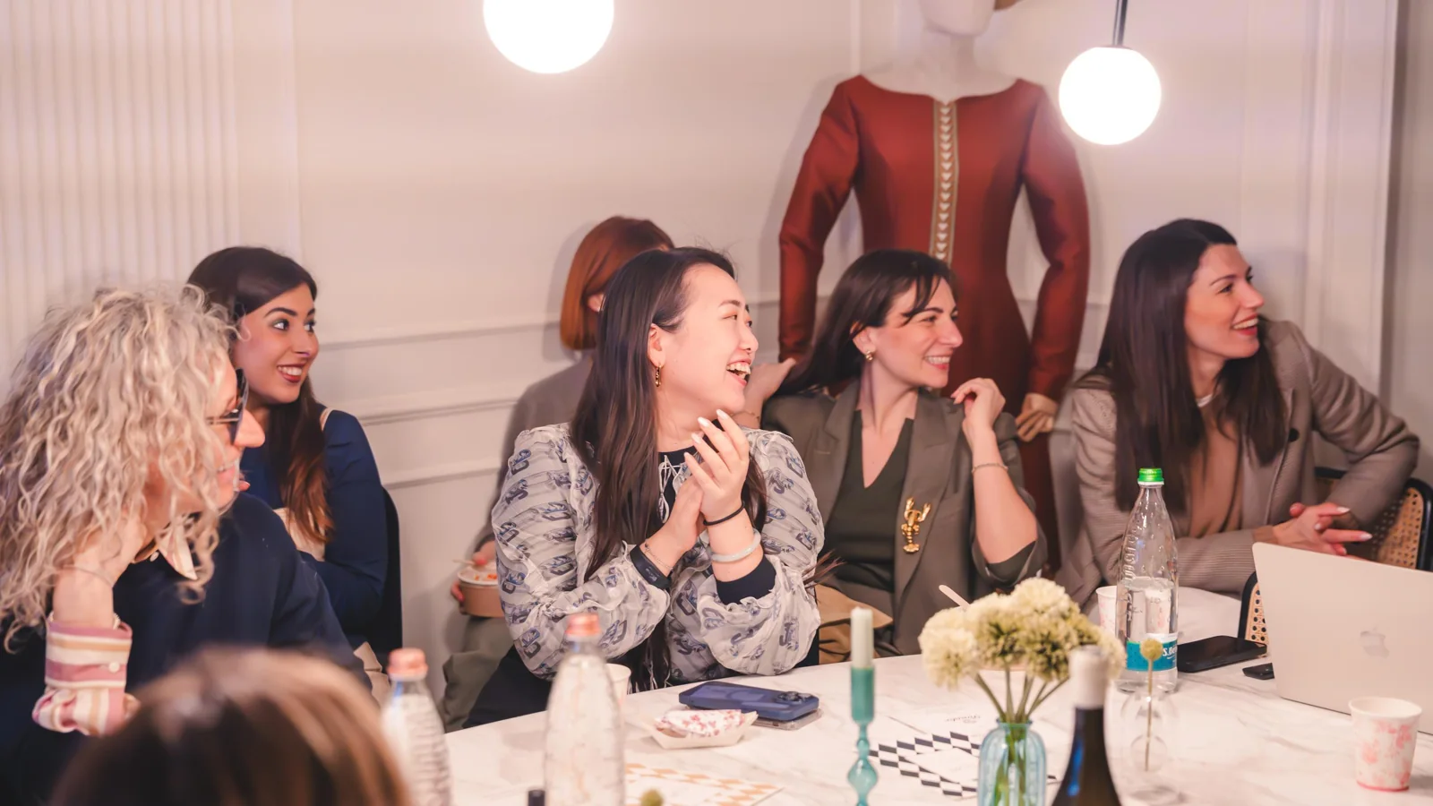 Women gathered around a TLWC table
